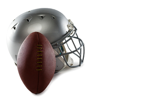 Close-up of helmet and American football on white background