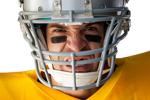 Close-up portrait of aggressive American football player wearing helmet