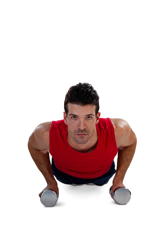 Portrait of determined sportsperson exercising with dumbbells against white background