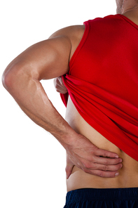 Cropped image of American football player suffering from back pain while standing against white background