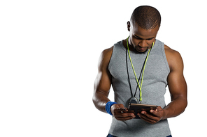 Male rugby instructor using digital tablet while standing against white background