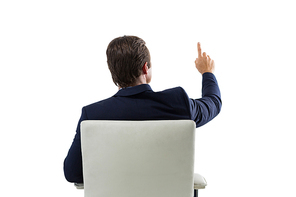 Rear view of businessman pressing an invisible virtual screen against white background