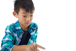 Boy pretending to touch an invisible screen against white background