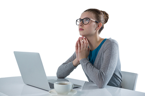 Thoughtful teenage girl using laptop against white background