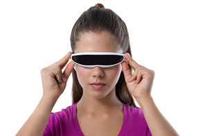 Teenage girl using virtual reality glasses against white background