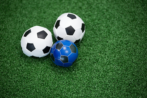 Close-up of footballs on artificial grass