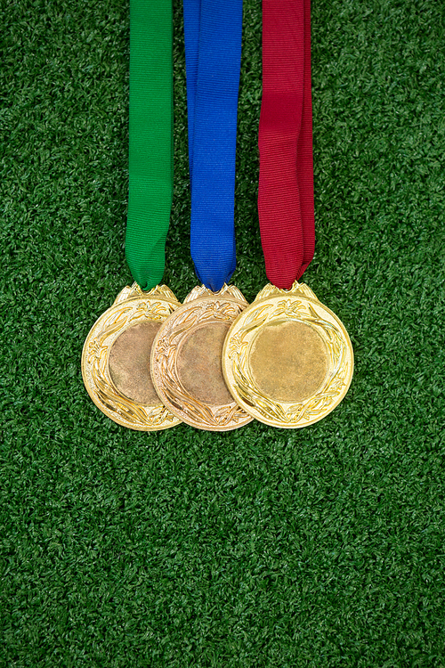 Close-up of medals on artificial grass