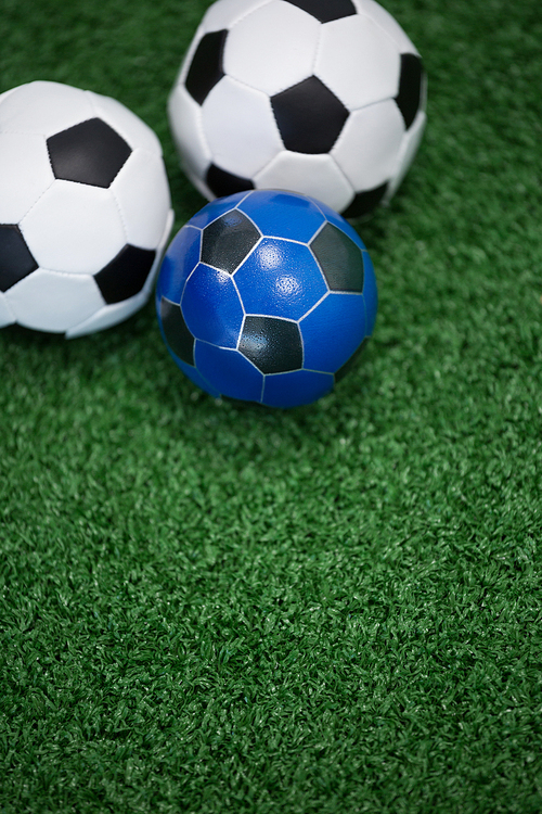 Close-up of footballs on artificial grass