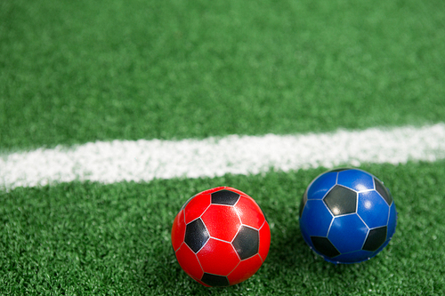 Close-up of footballs on artificial grass