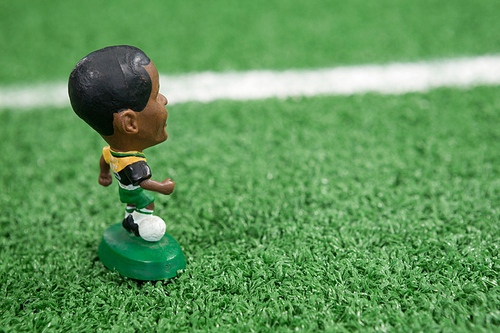 Close-up of miniature on artificial grass