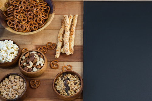 Overhead of various snacks on wooden table