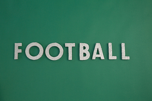 Close-up o word football arranged on green background