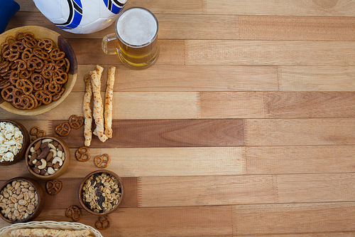 Overhead of fresh snacks and beer on wooden table