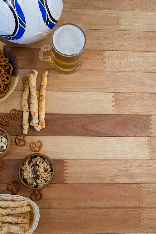 Overhead of fresh snacks and beer on wooden table