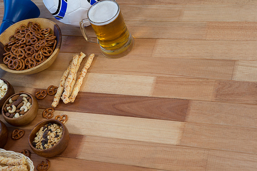 Various fresh snacks and beer on wooden table