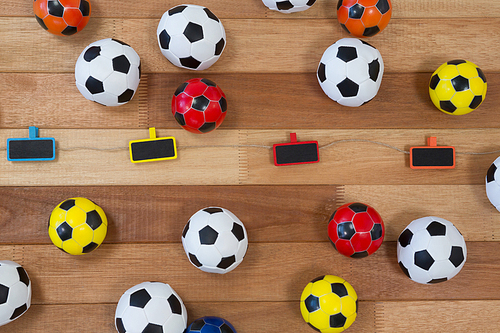 Overhead of colorful footballs on wooden table