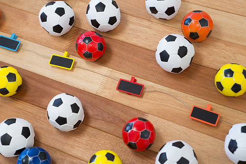 Overhead of colorful footballs on wooden table