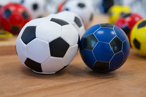 Close-up of footballs on wooden table