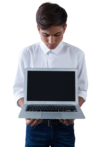 Boy holding laptop against white background