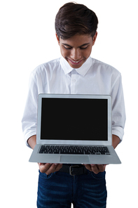 Boy holding laptop against white background