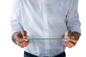 Mid section of teenage boy holding a glass digital tablet