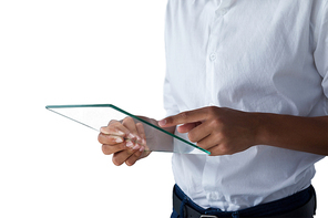 Mid section of teenage boy using a glass digital tablet