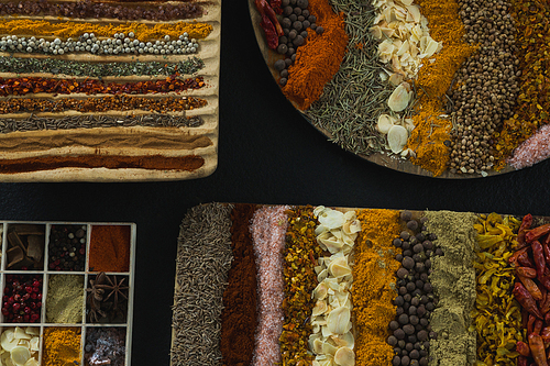 Overhead of various spices and seeds in tray