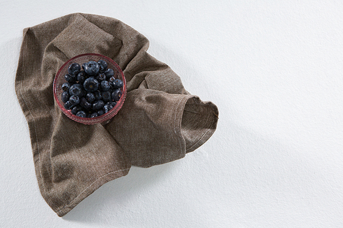Close-up of blueberries in bowl on a textile