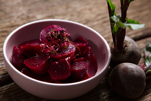 Close-up of beetroot slice in bowl on wooden table