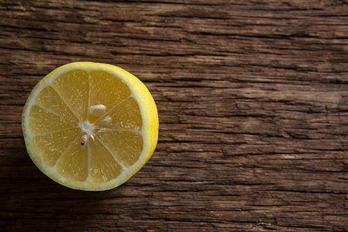 Close-up of halved lemon on wooden table