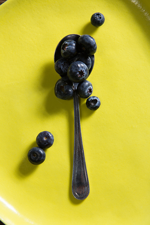 Close-up of blueberries in yellow plate