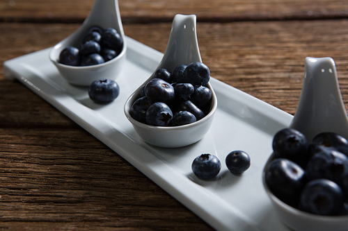 Close-up of blueberries in spoon arranged on tray