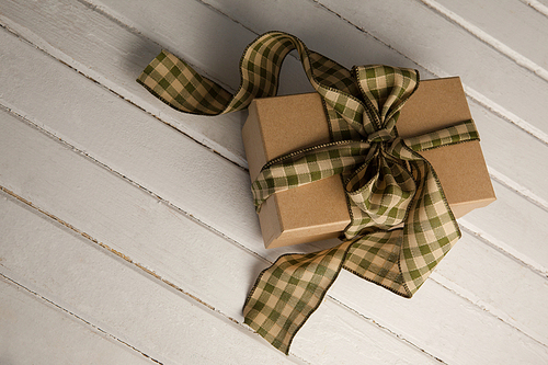 High angle view of tied gift box on white table