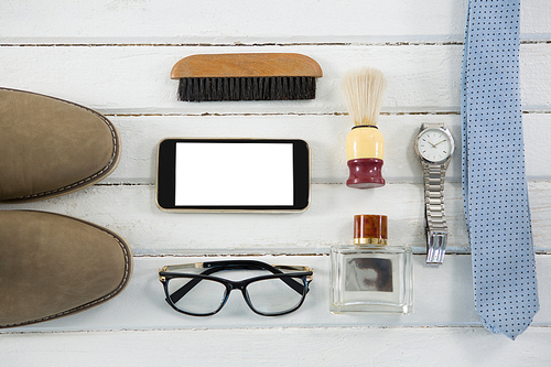 Flat lay of accessories on white wooden table