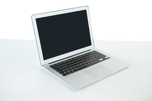 Close up of laptop computer on table against white background