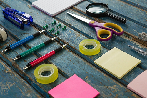 Close-up of office accessories on wooden plank