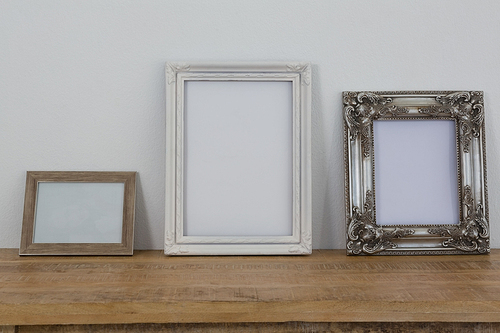 Variety of frames arranged on wooden table