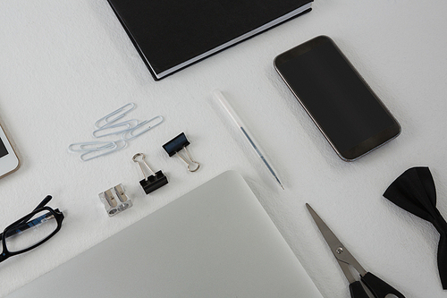 Overhead of various office accessories on white background