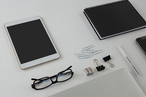 Close-up of various office accessories on white background