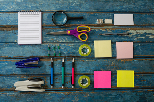 Overhead of office accessories on wooden plank