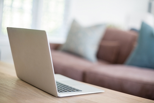 Close-up of laptop on table in living room at home