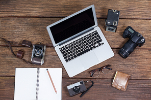 Close-up of laptop with cameras on table in studio