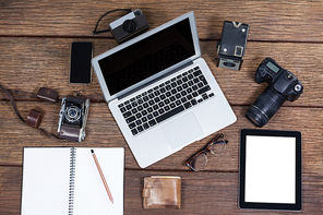 Close-up of laptop with cameras on table in studio