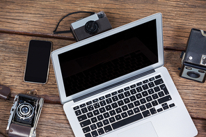 Close-up of laptop with cameras on table in studio