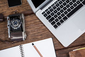 Close-up of laptop with camera on table in studio