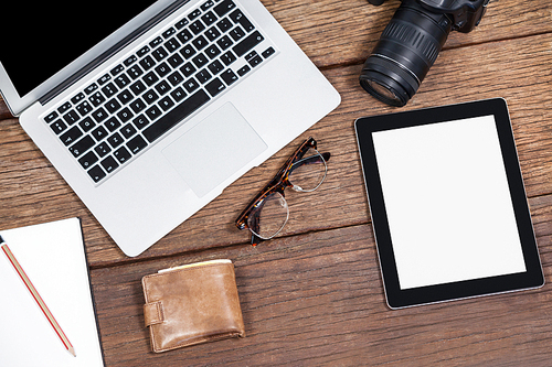 Close-up of laptop with camera on table in studio