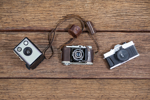 Close-up of old fashioned cameras on table in studio