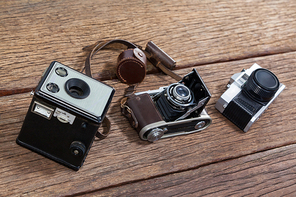 Close-up of old fashioned cameras on table in studio