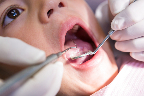 Close-up of boy receiving dental treatment at clinic