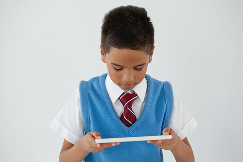 Schoolboy using digital tablet against white background